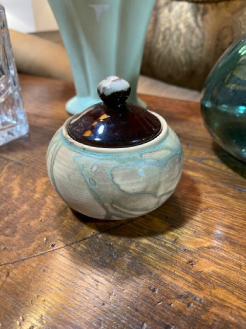 Small round ceramic vase with brown lid